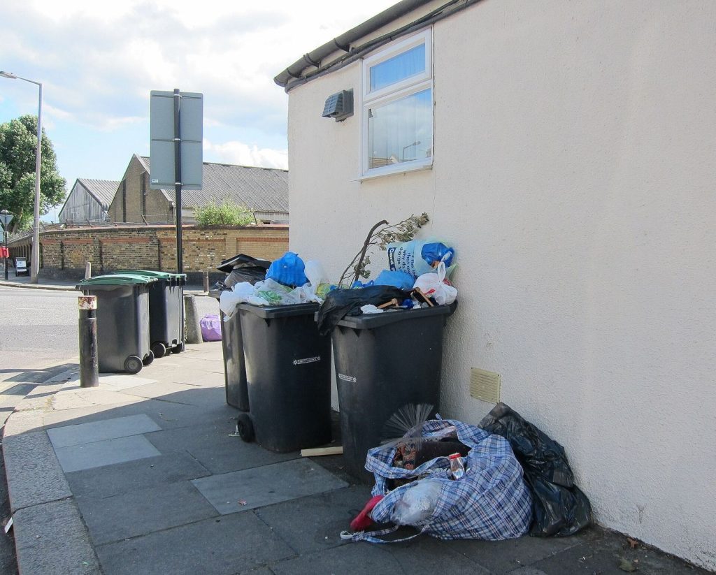Recycling Centres Add Repair Sessions Alongside Drop-Off recycling bins along a residential street